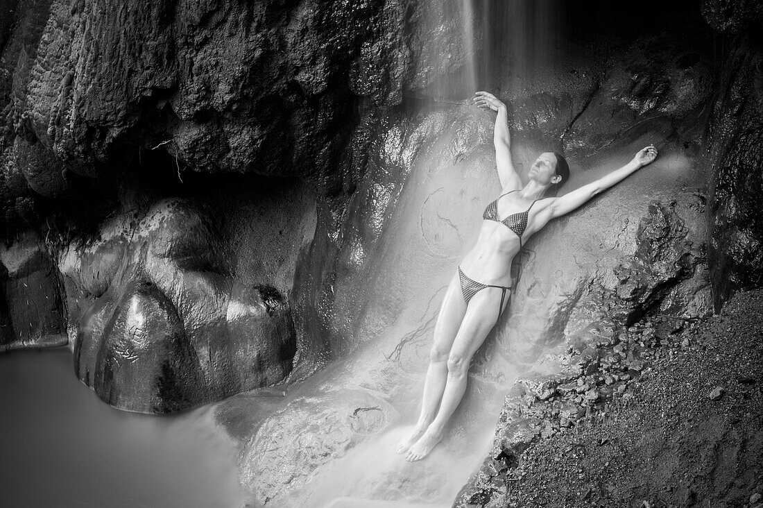 Woman under a waterfall, Caribbean