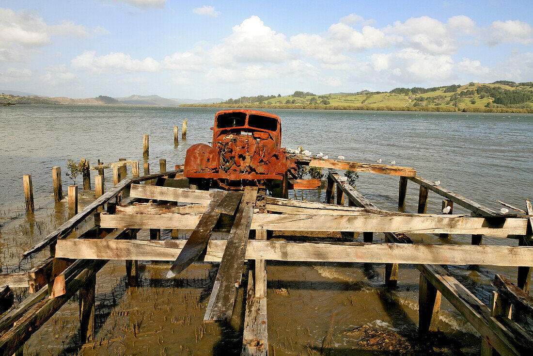 blocked for illustrated books in Germany, Austria, Switzerland: Rusty old American pickup truck on the jetty, forgotten, Hokianga Harbour, Northland, New Zealand