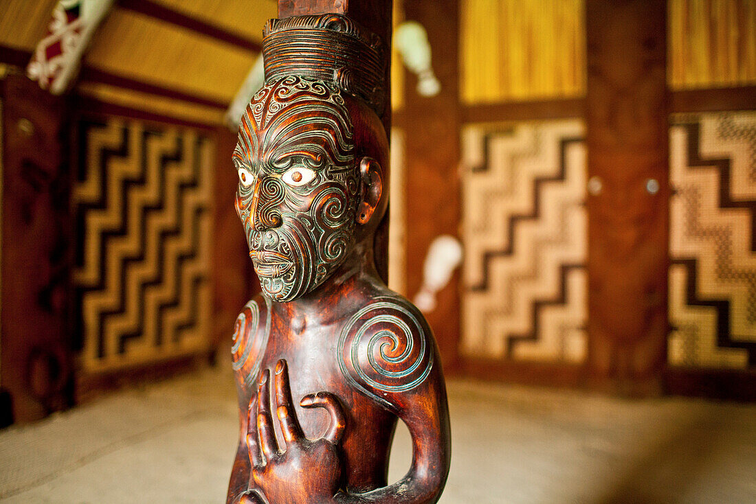 blocked for illustrated books in Germany, Austria, Switzerland: Carved wooden ancestral sculpture with spiral tatoos in the Maori traditional meeting house at Okains Bay, carved meeting house representing all tribes, Te Whare Runanga, Okains Bay, Banks Pe