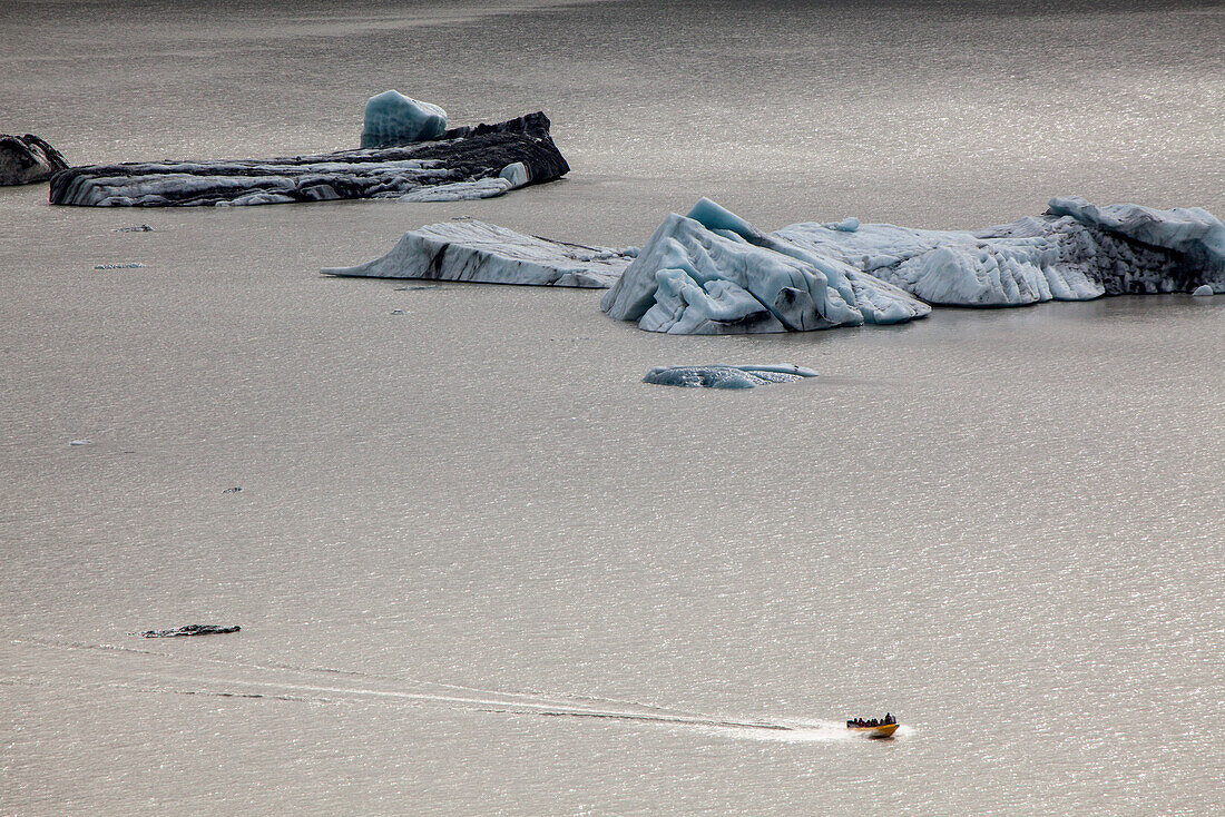 Tasman lake with icebergs at the end of the Tasman Glacier, motorboat, near Mount Cook National Park, South Island, New Zealand