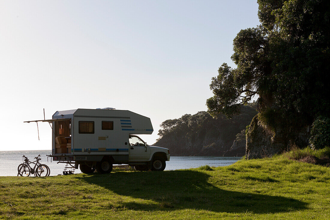 4WD camper van parked on the beach, small camping ground, East Cape, North Island, New Zealand
