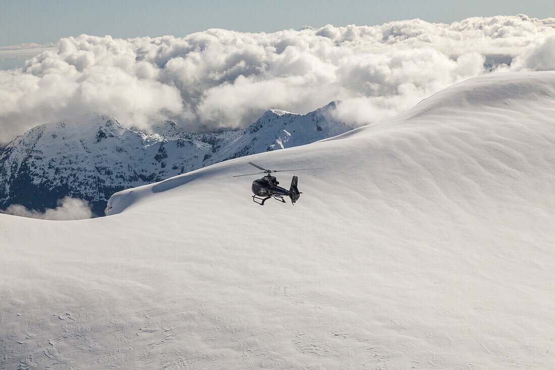 Helicopter flight over snowy mountains, South Island, New Zealand