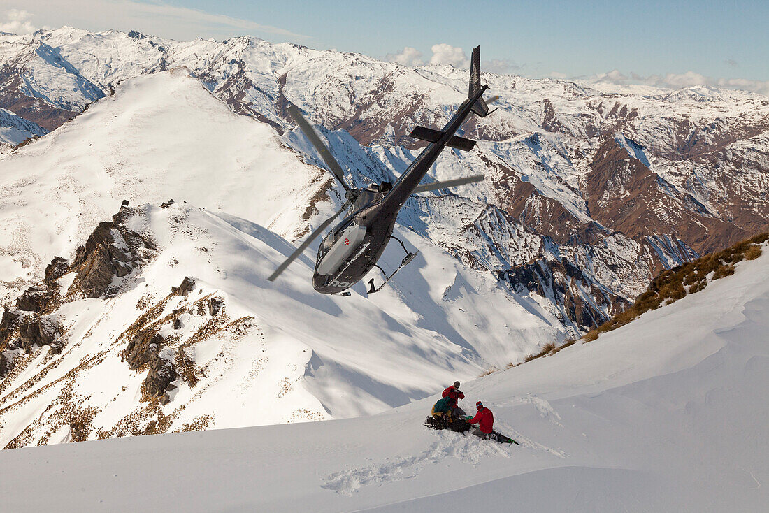 Helicopter landing with skiers and snowboarders, winter sports, Queenstown, South Island, New Zealand