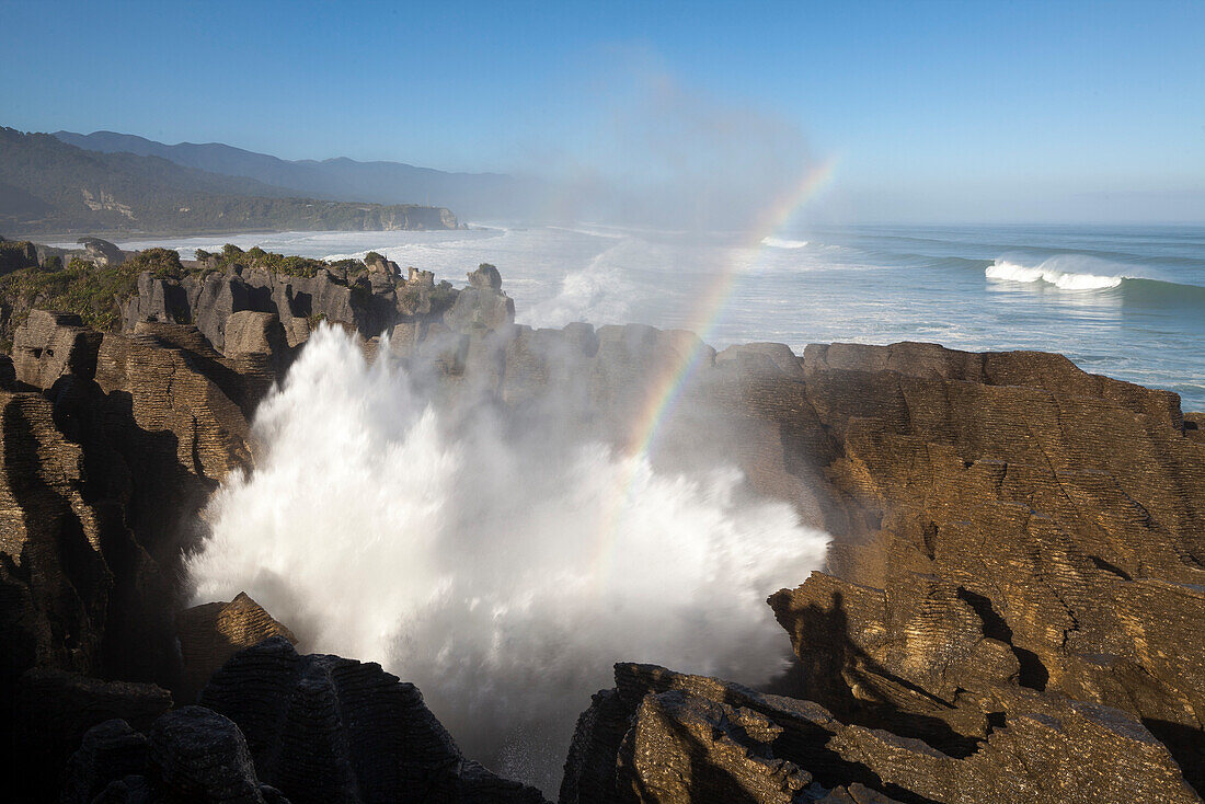 Rainbow over Pancake rocks at Punakaiki, Dolomite Point, Tasman Sea, South Island, New Zealand