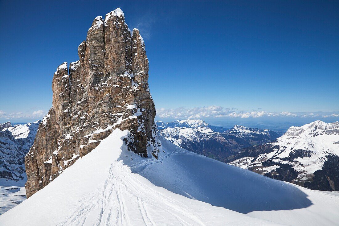 A view of ski tracks and a rock formation on Mount Titlis near Engelberg, Switzerland, in the Ulmer Alps