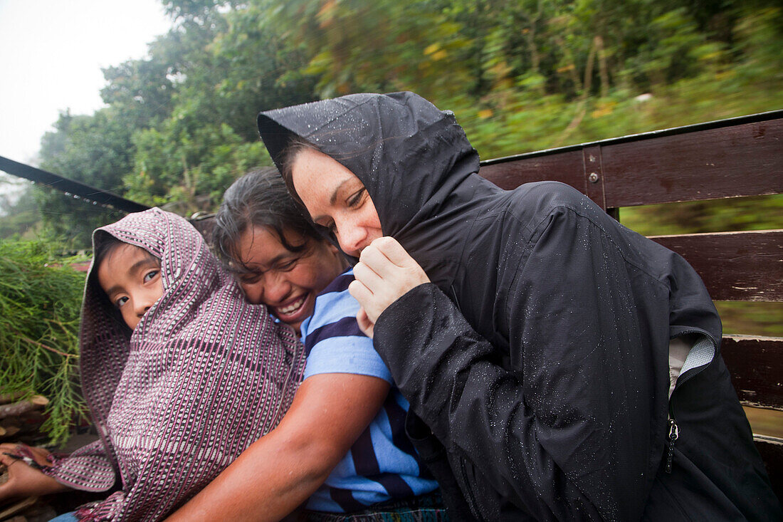 Women and Child Riding on Truck in Rain, Guatemala