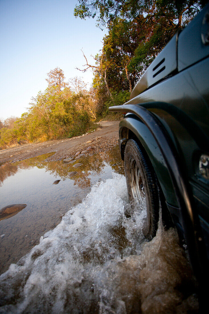 Jeep Driving Through Puddle in Dirt Road, India