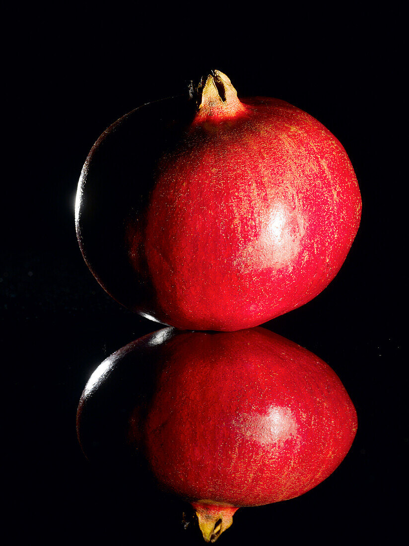 Pomegranate With Reflection on Black Background
