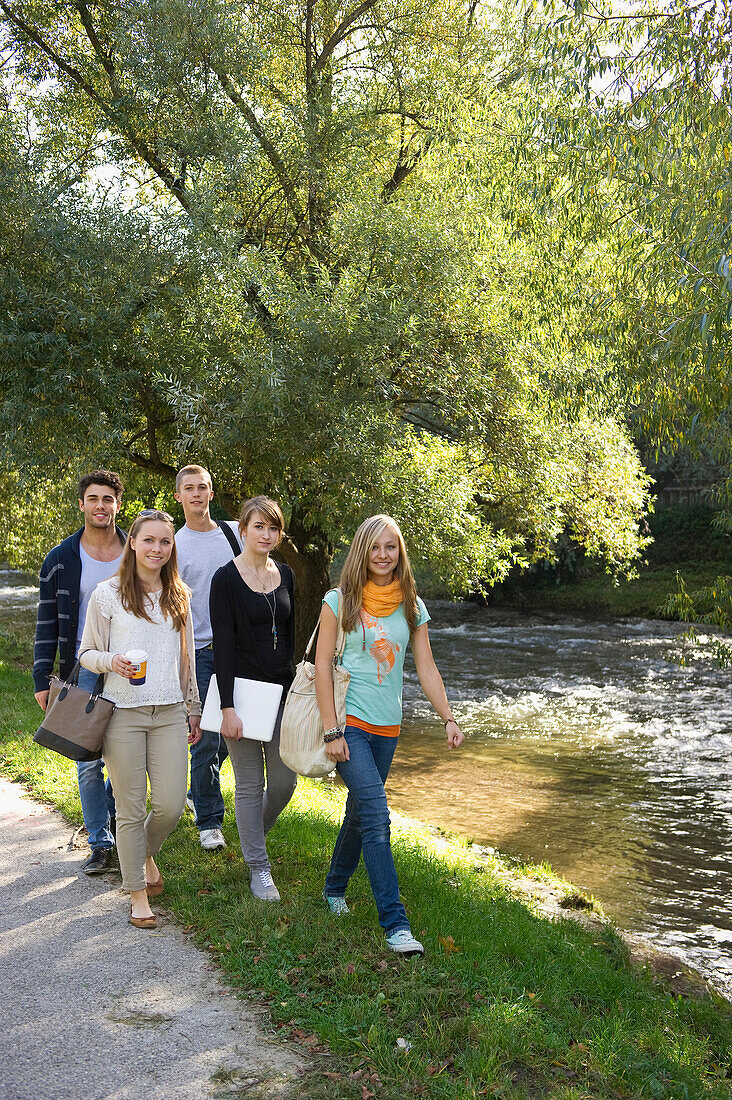 Young people walking along Dreisam river, Freiburg im Breisgau, Black Forest, Baden-Wurttemberg, Germany