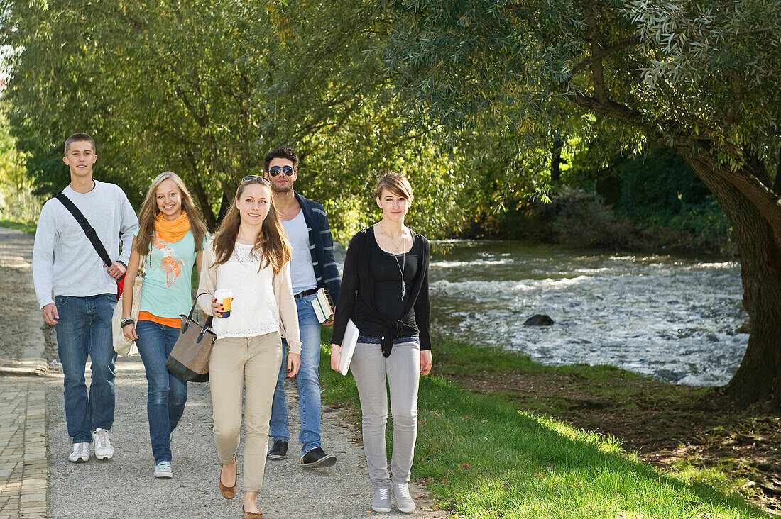 Young people walking along river Dreisam, Freiburg im Breisgau, Black Forest, Baden-Wurttemberg, Germany