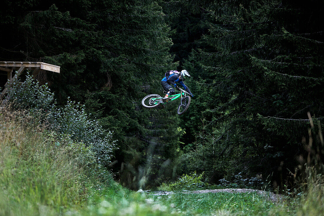 Freeride mountain biker jumping, Chatel, Haute-Savoie, France