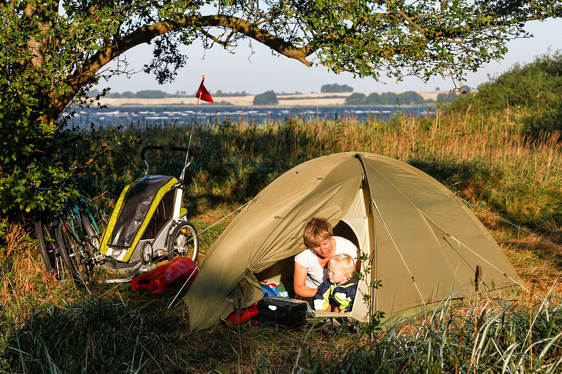 Mother and son (2 years) sitting in a tent, Neu Reddevitz, Island of Ruegen, Mecklenburg-Western Pomerania, Germany