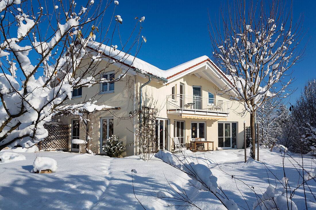 Detached family house with garden in winter, Upper Bavaria, Germany