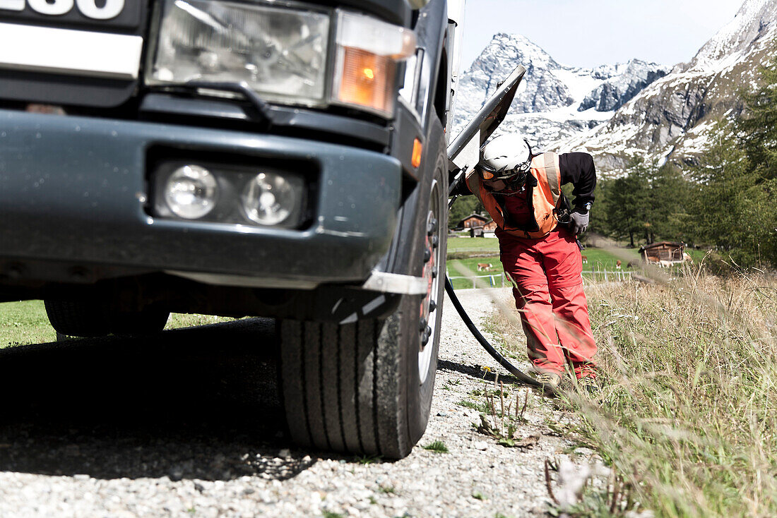 Man checking a tanker, Grossglockner, Tyrol, Austria