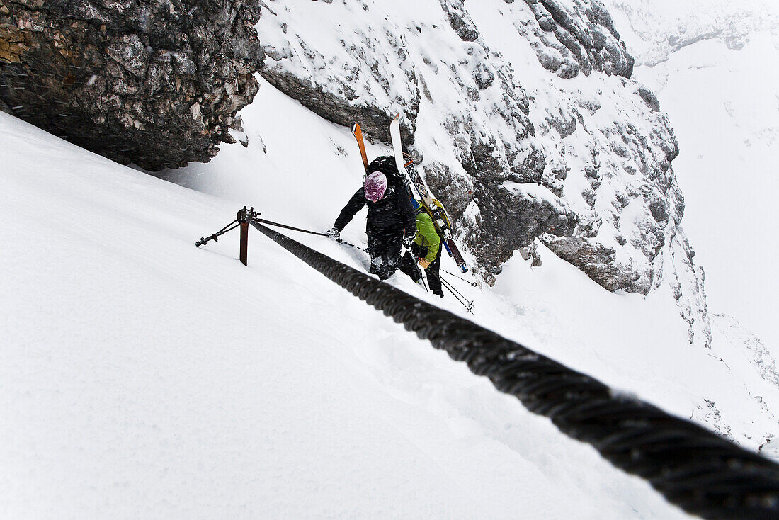 Two skiers ascending to mount Alpspitze, Garmisch-Partenkirchen, Bavaria, Germany