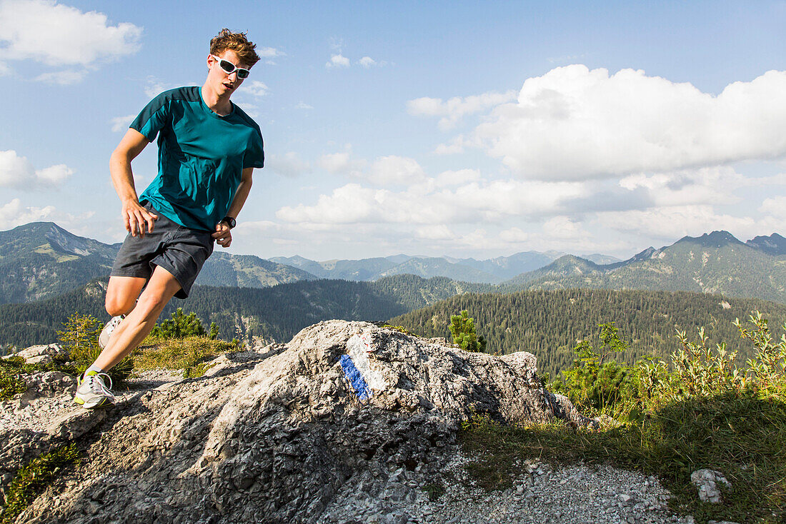 Man running on a mountain path, Risserkogel, Isarwinkel, Bavaria, Germany