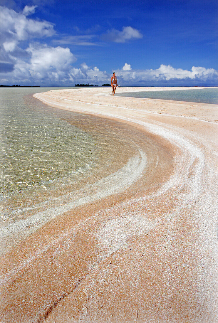 French Polynesia, Tahiti, Rangiroa, Pink sands beach with woman in the distant.