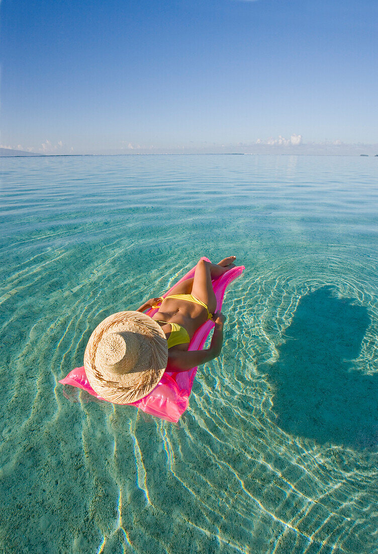 French Polynesia, Tahiti, Moorea, Woman floating in water.