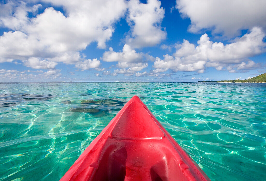 French Polynesia, Tahiti, Bora Bora, Red outrigger canoe in calm turquoise water.