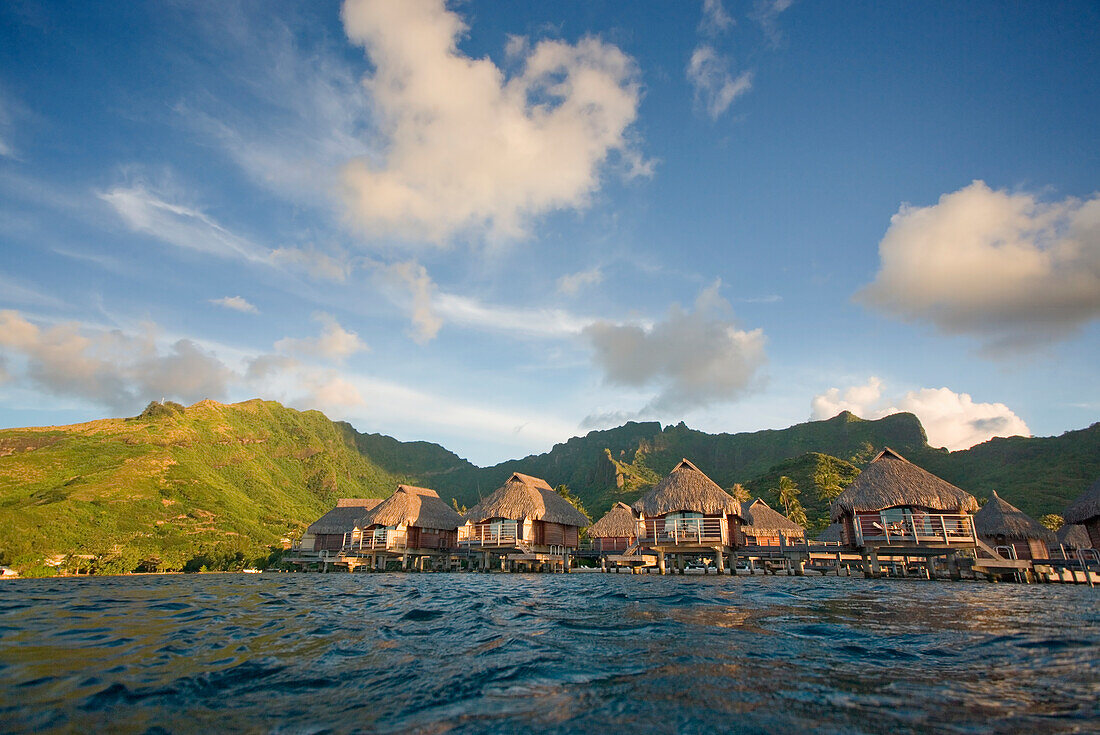 French Polynesia, Moorea Lagoon Resort, Bungalows over beautiful turquoise ocean.