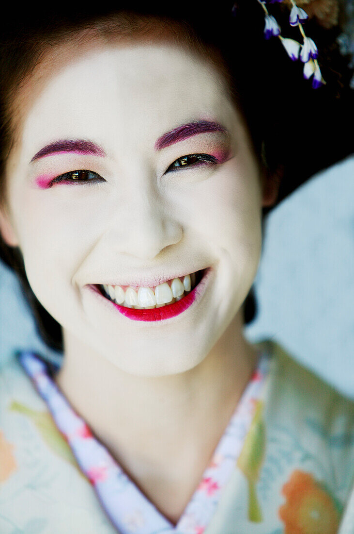 Portrait of Japanese Maiko with big smile.
