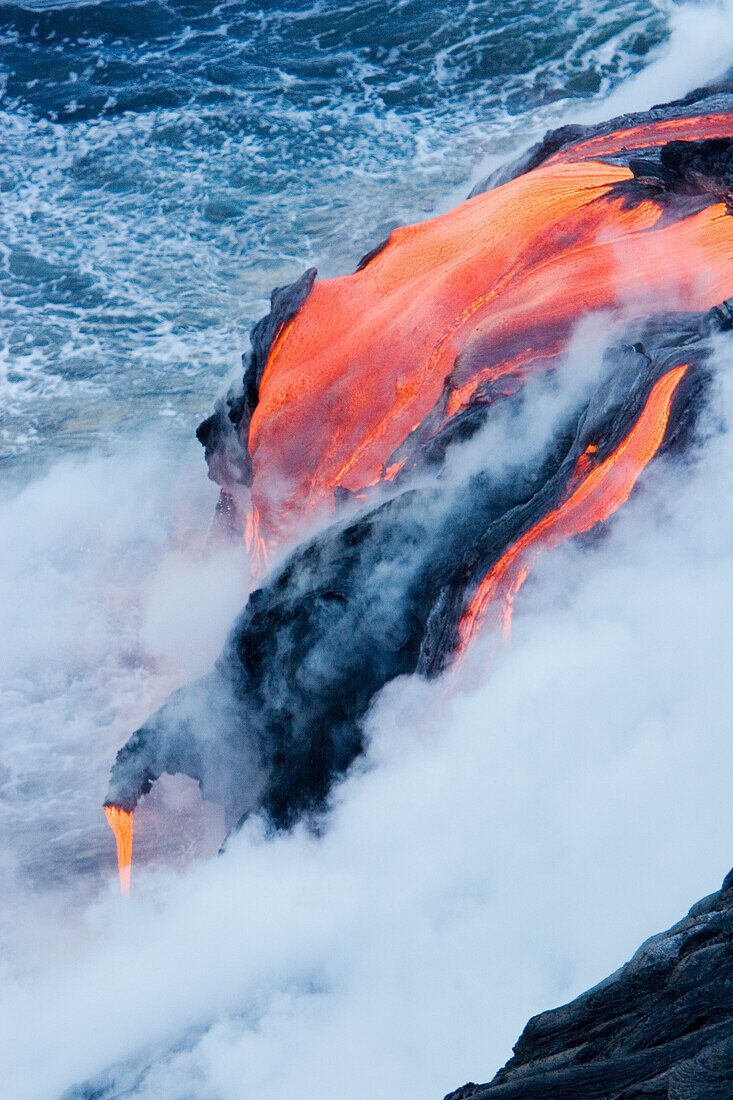 Hawaii, Big Island, near Kalapana, Pahoehoe lava flowing from Kilauea into Pacific Ocean.