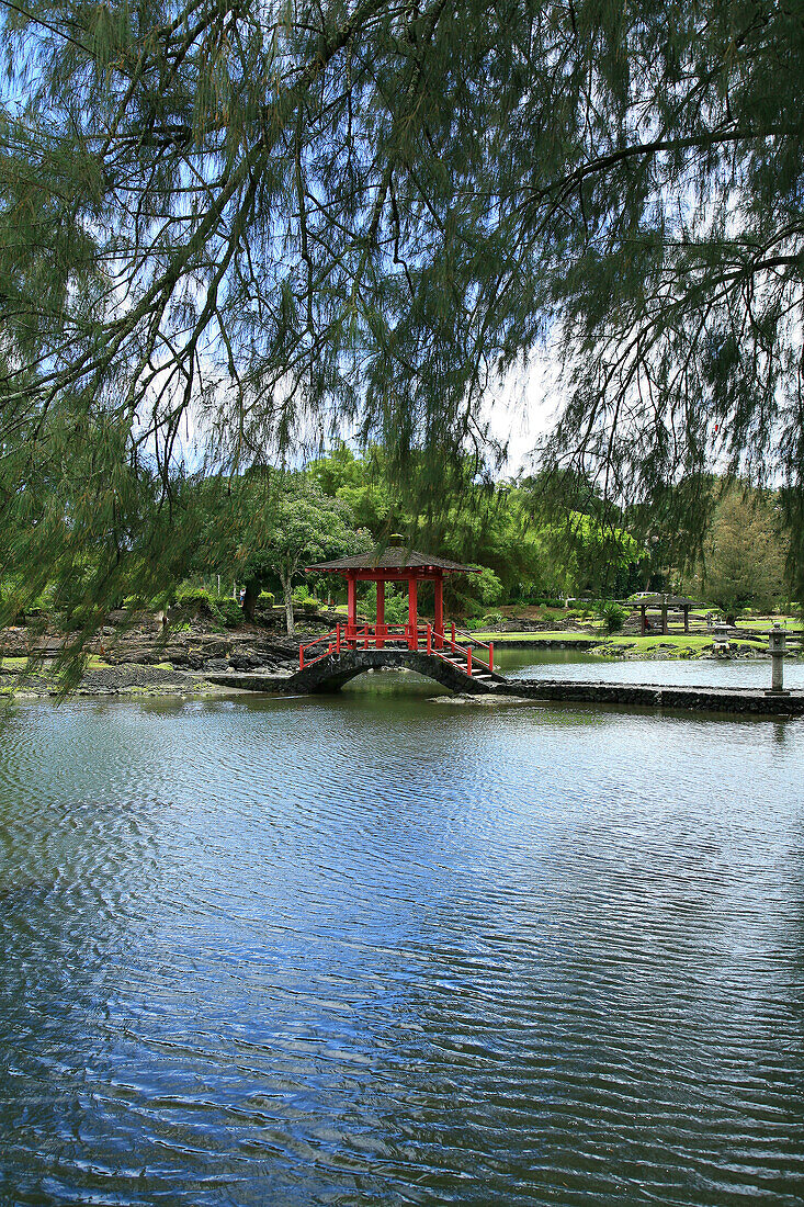 Hawaii, Big Island, Hilo, Liliuokalani Gardens. Red pagoda bridge over water.