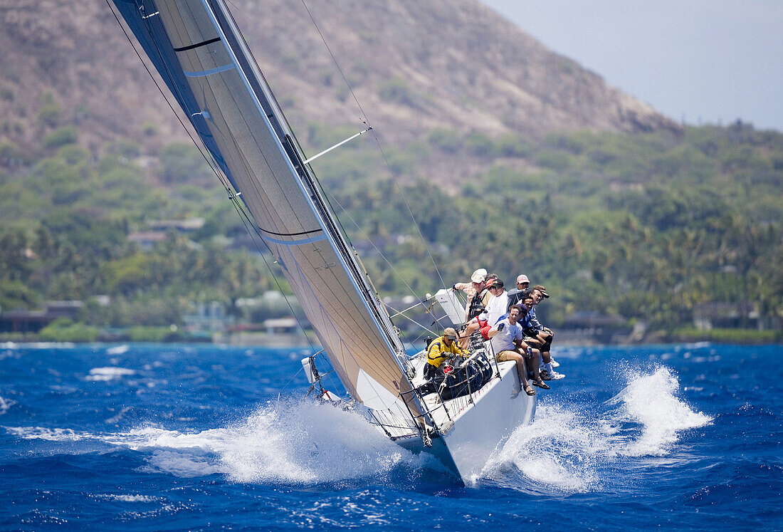 Hawaii, Oahu, Waikiki Offshore Series 2005, sailboat on blue ocean, land in background.