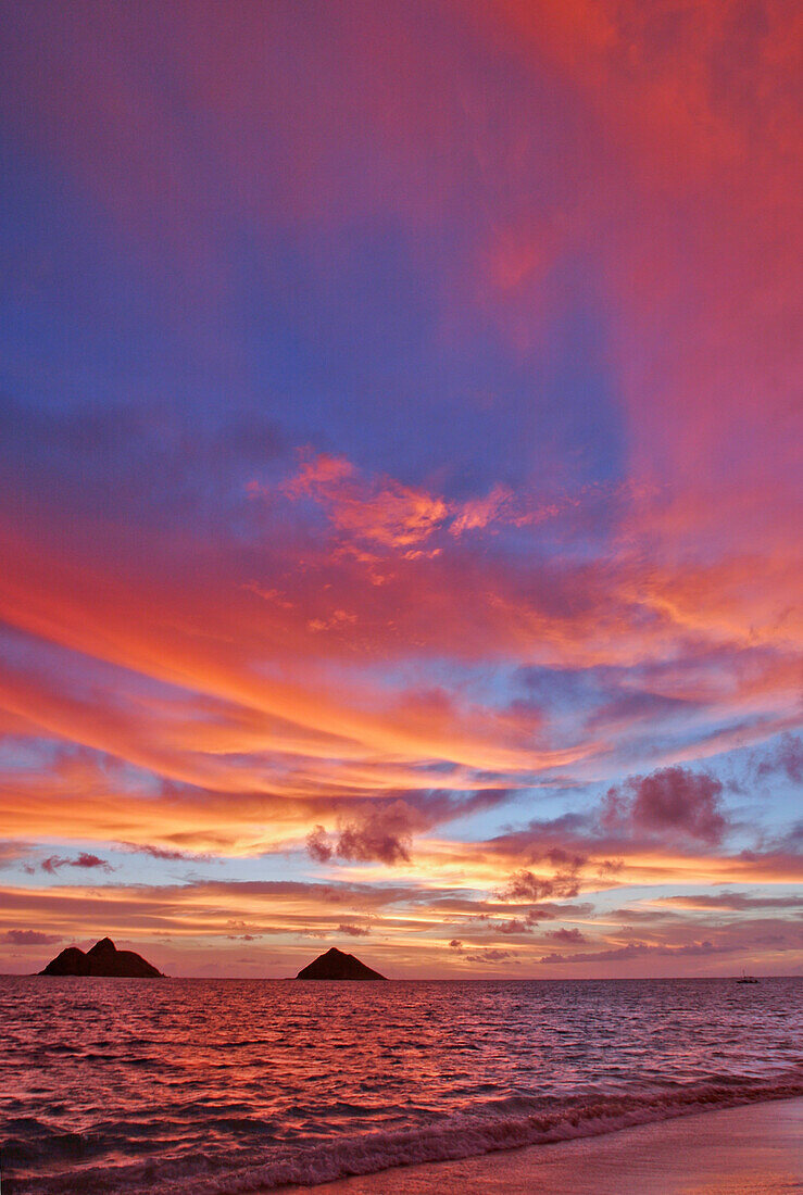 Hawaii, Oahu, Lanikai, A colorful pink sunrise over the Mokulua islands.