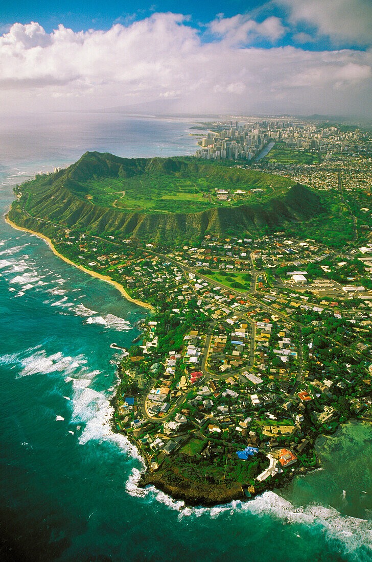 Hawaii, Oahu, Coastline aerial of Kahala homes and Diamond Head Crater, Waikiki hotels background