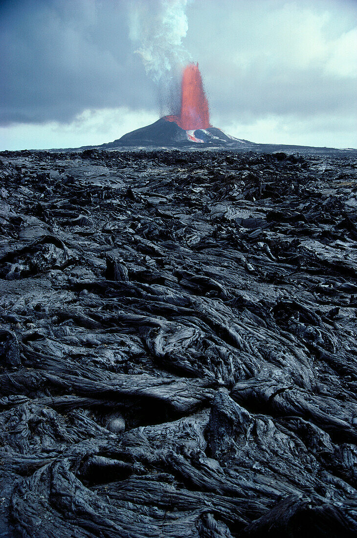 Hawaii, Big Island, Pu'u O'o eruption, pahoehoe lava in foreground, fountain background A27F