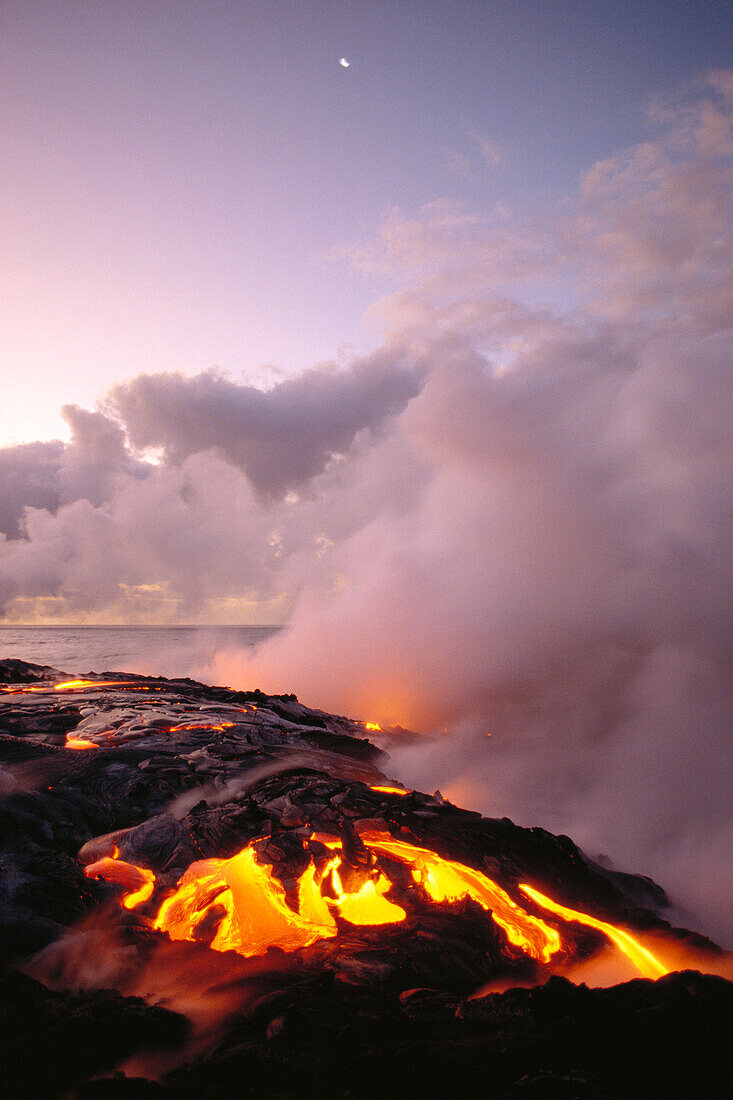 Hawaii, Big Island, Hawaii Volcanoes National Park, Sunrise at ocean front with lava flow, smoky skies