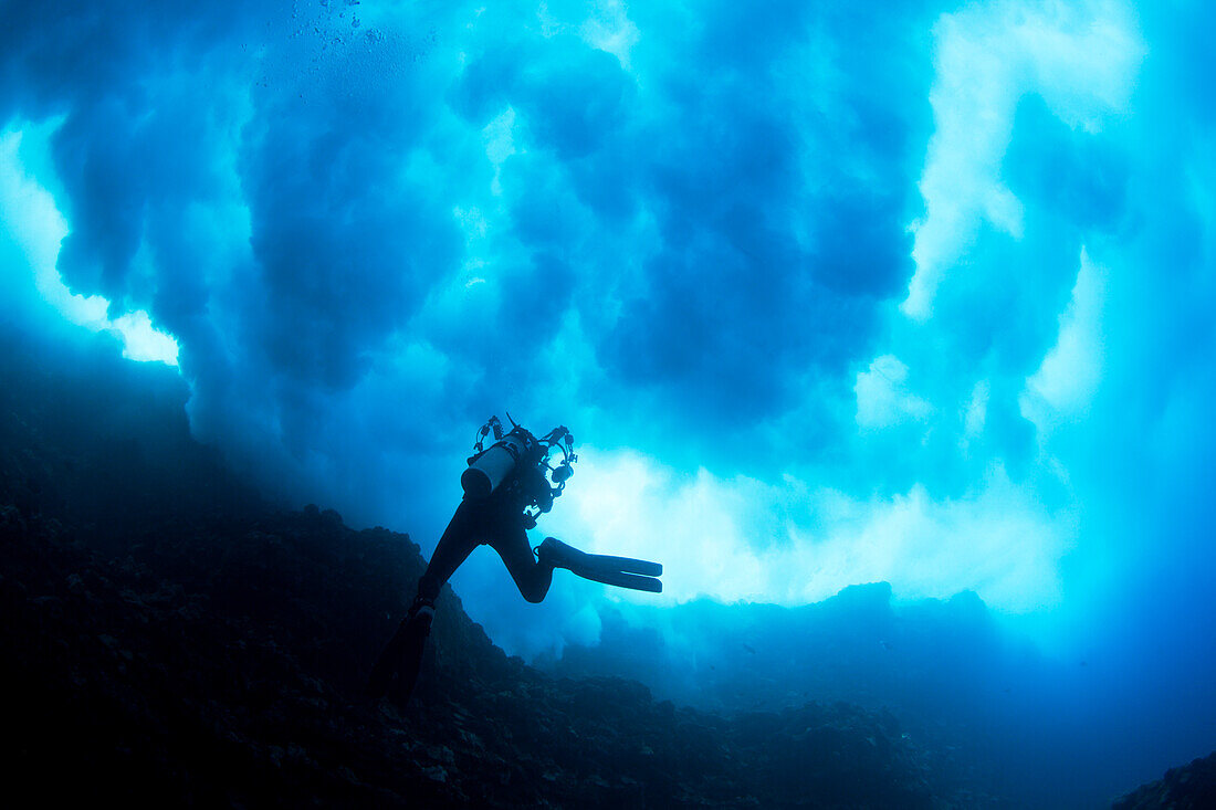 Hawaii, Lanai, Diver near Cathedral underneath a billowing wave.