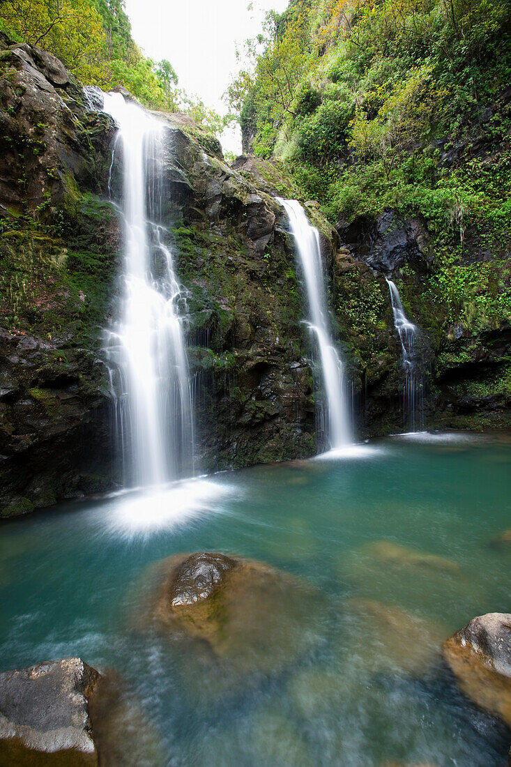 Hawaii, Maui, Hana, The three Waikani Falls with a clear blue pond on The Road To Hana