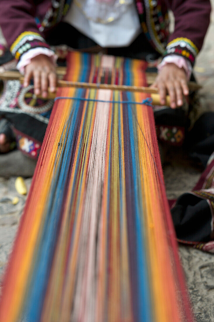 'A Person Weaving Colorful Fabric; Cusco Peru'