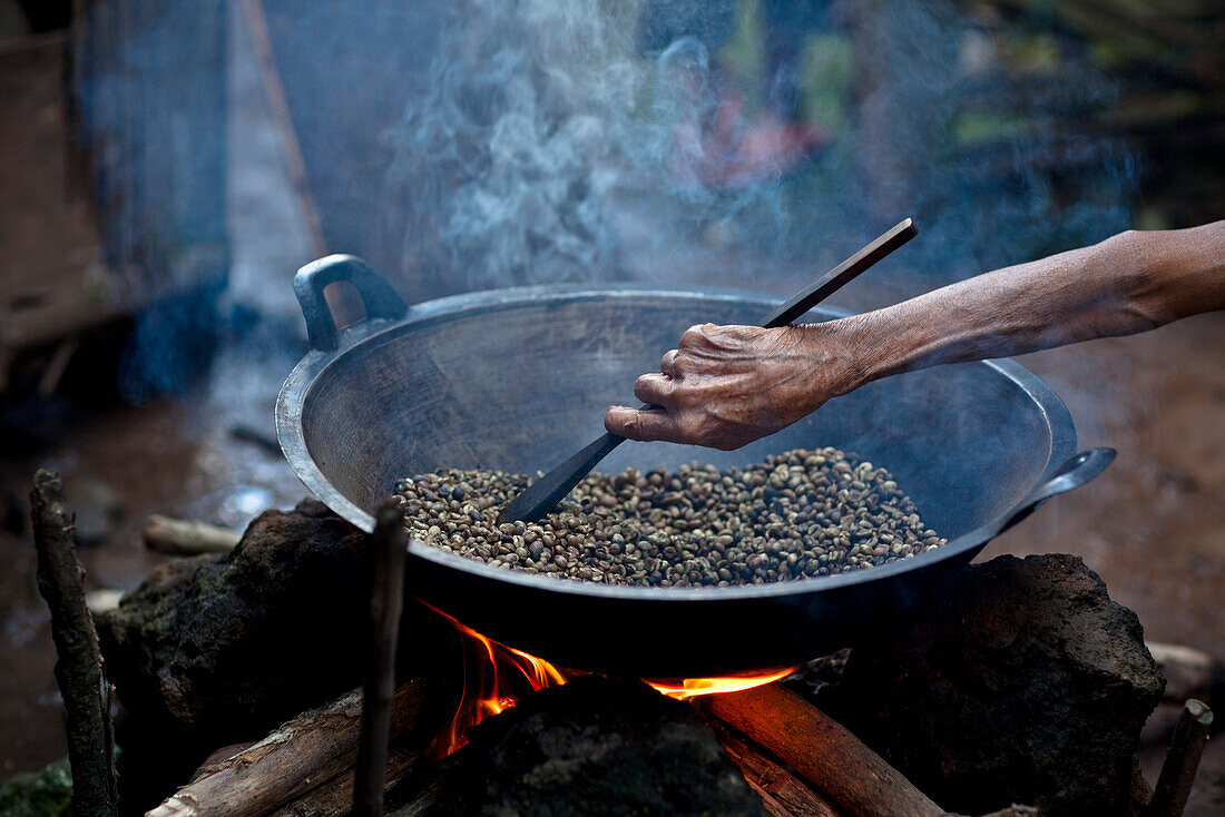 'Hand Stirring Coffee Beans Over Fire; Muara Pinang Indonesia'