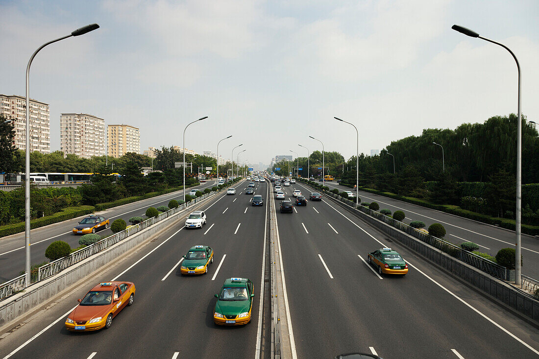 Taxis and other cars drive the second ring road around Beijing, China., Beijing, China. Modern ring road.