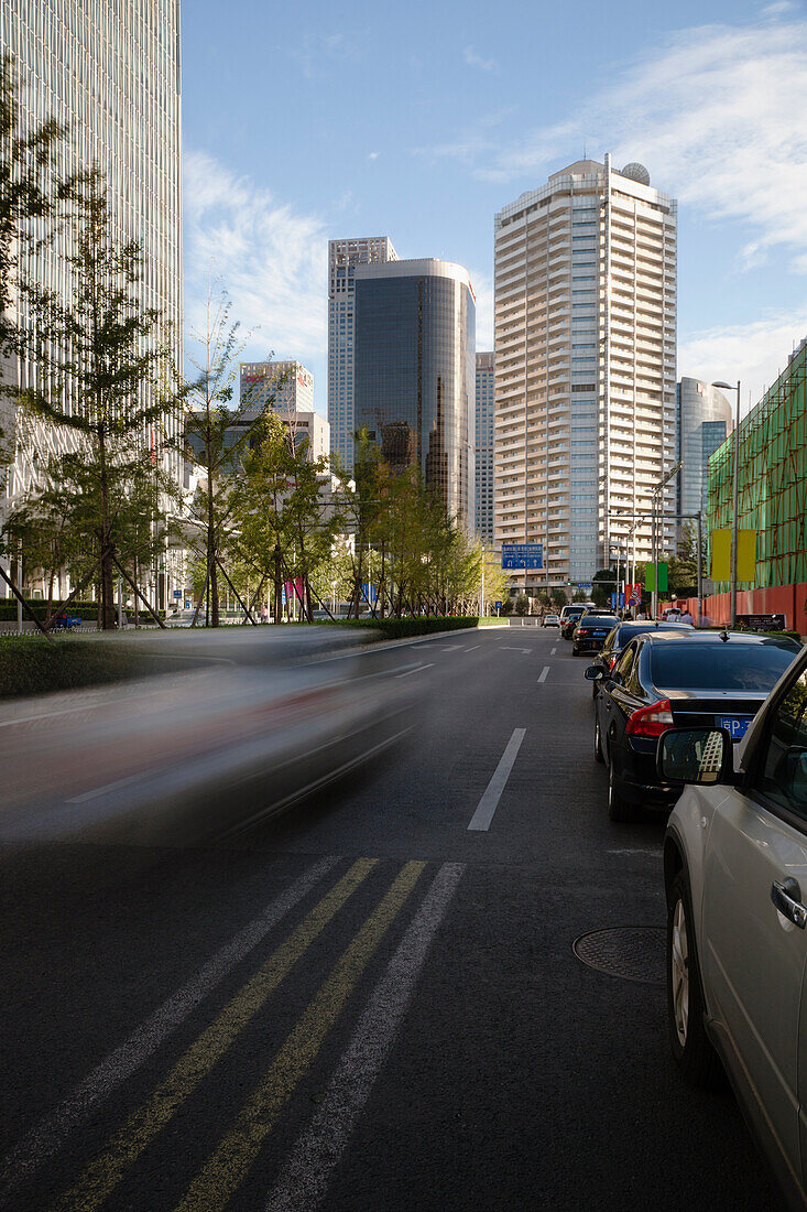 A car runs down a street in the Central Business District of Beijing, China., Beijing, China.