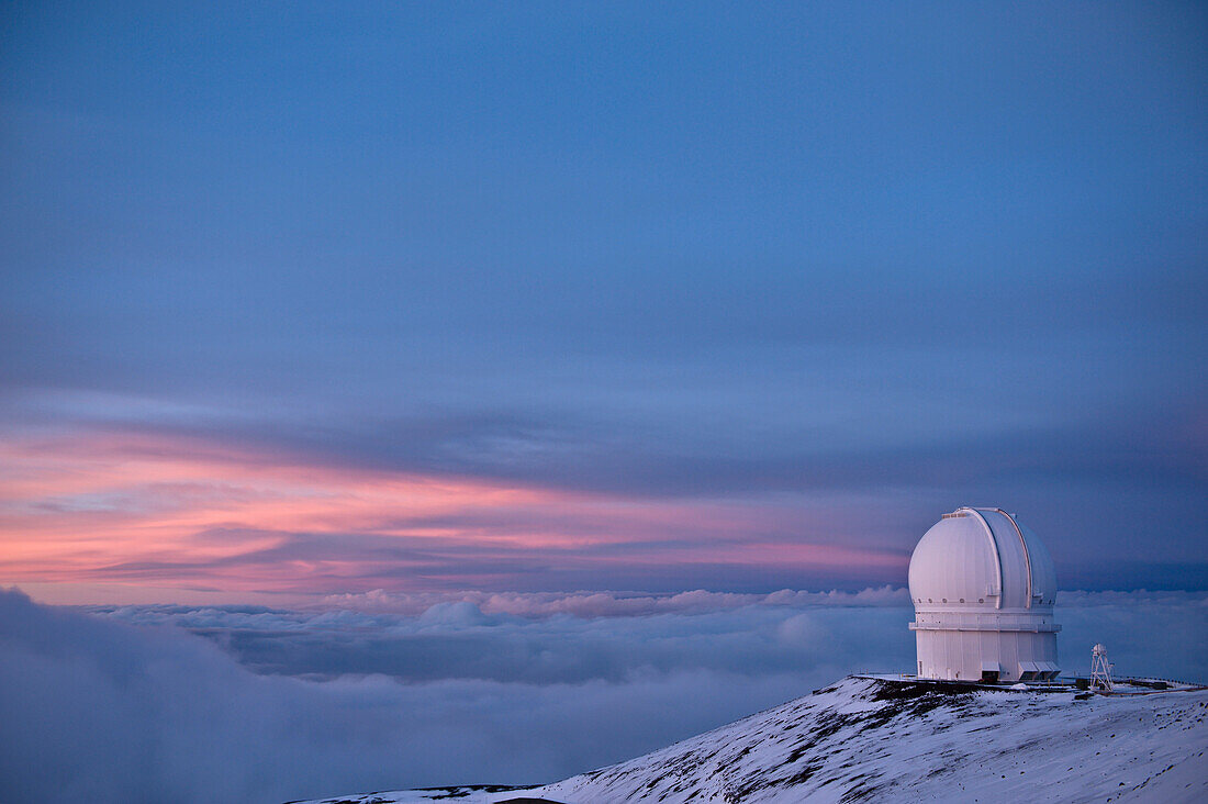 The Canada-France-Hawaii Observatory in the evening light on Mauna Kea on hawaii. A building on the mountain top with a dome, Telescope. Sunset., Canada-France Telescope