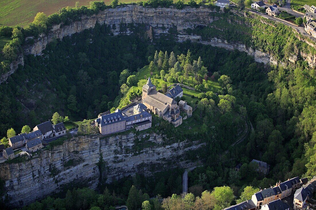 France, Aveyron (12), Bozouls village around the bend of a small river, which carved a natural amphitheater called the Hole Bozouls, Church of St. Faustus, (aerial photo)