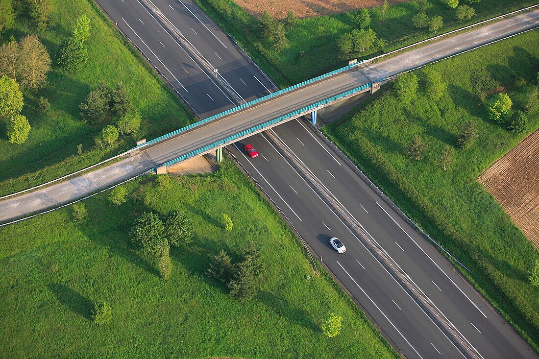 France, crossing the road has heavy traffic, with a bridge crossing a secondary road, (air photo)