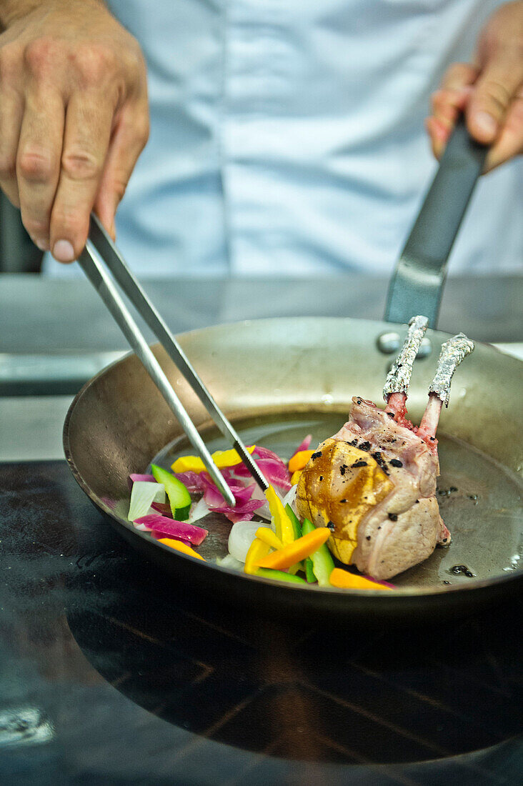 Chef preparing roasted lamb chops and vegetables, Hotel Castagnola, Lugano, Ticino, Switzerland