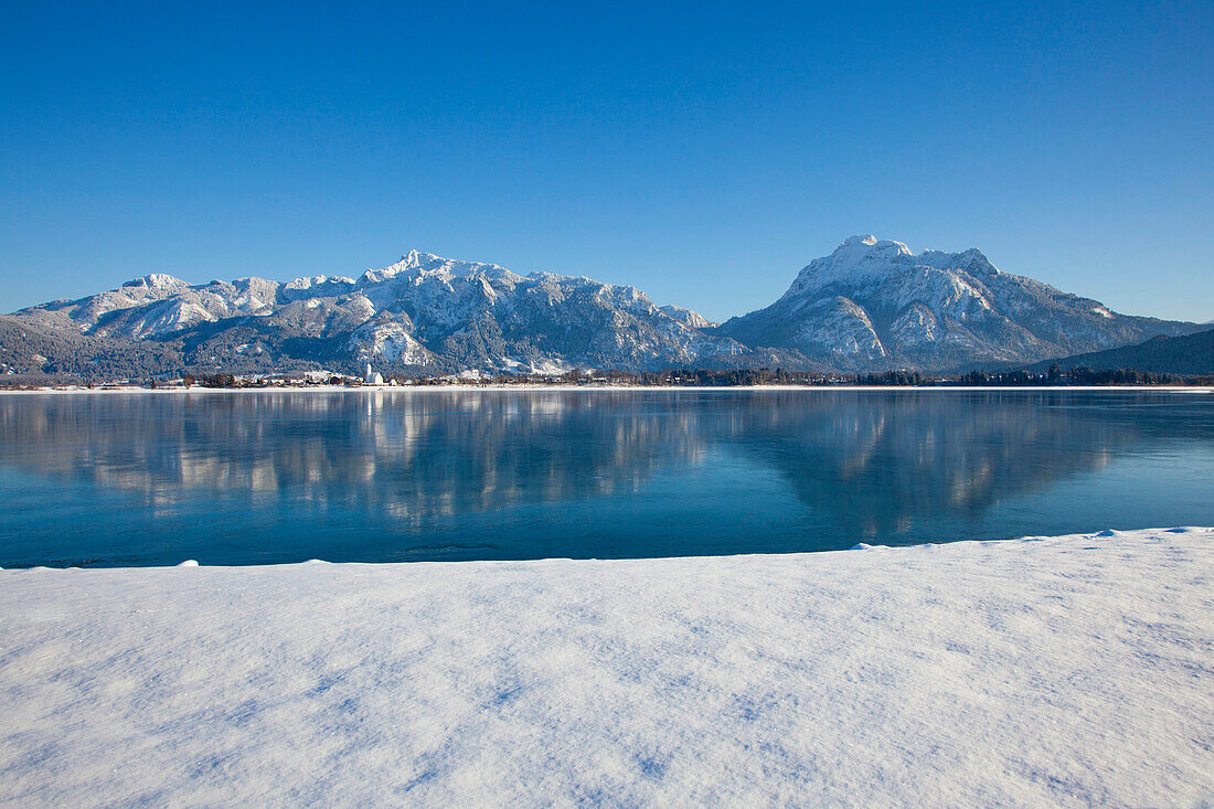 View across Lake Forggensee to the Allgaeu Alps with Tegelberg and Saeuling, Allgaeu, Bavaria, Germany