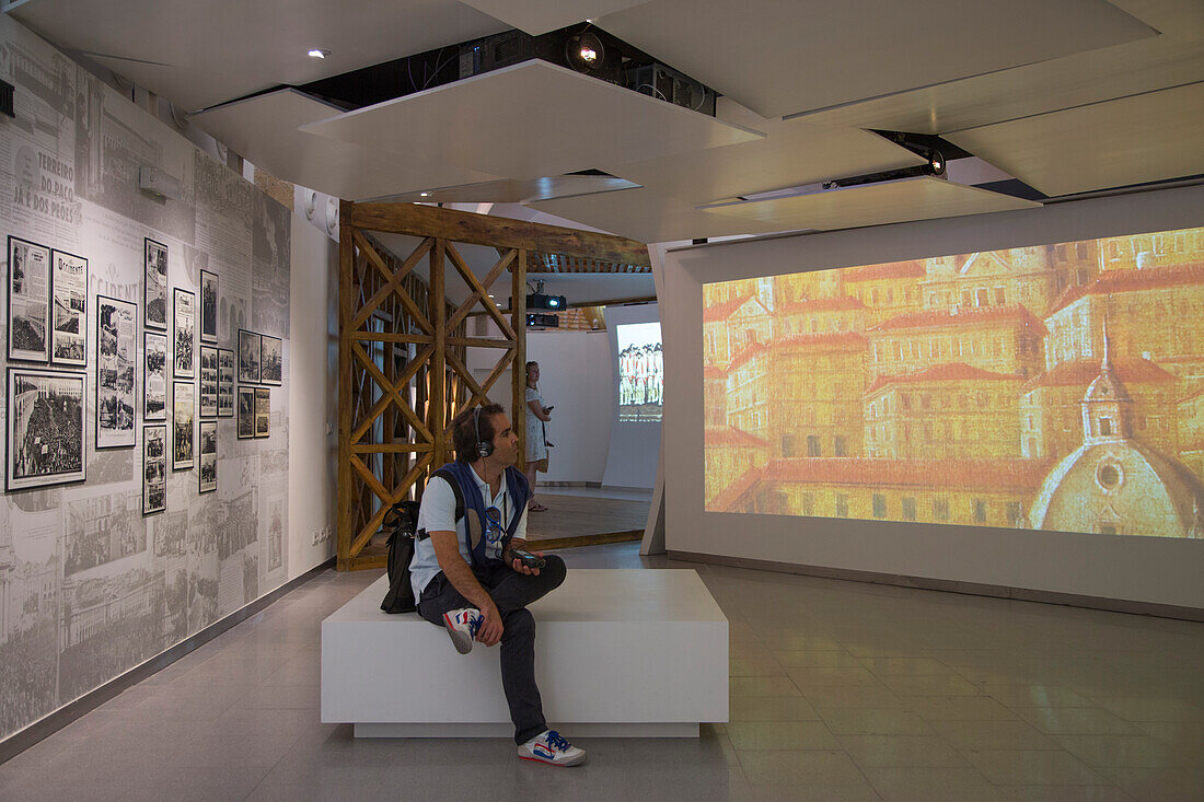 Person enjoying a multimedia display at Lisboa Story Centre at Praca do Comercio square in Baixa district, Lisbon, Lisboa, Portugal