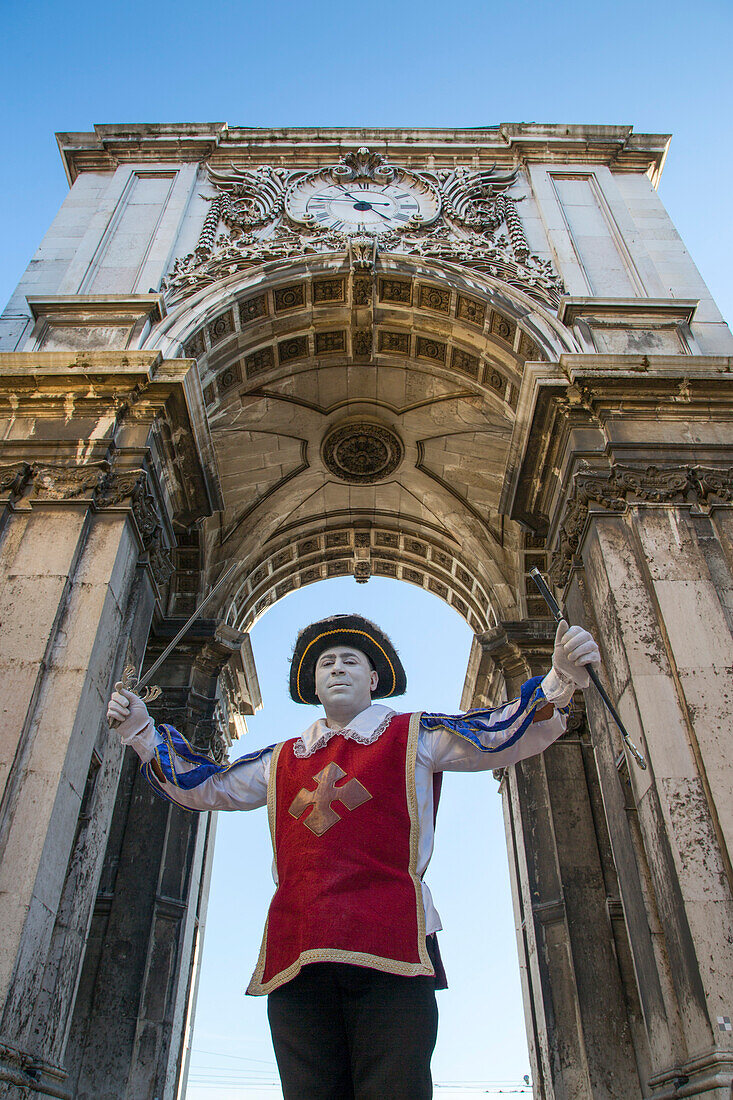 Street performer underneath Arco da Victoria victory arch at Praca do Comercio square in Baixa district, Lisbon, Lisboa, Portugal