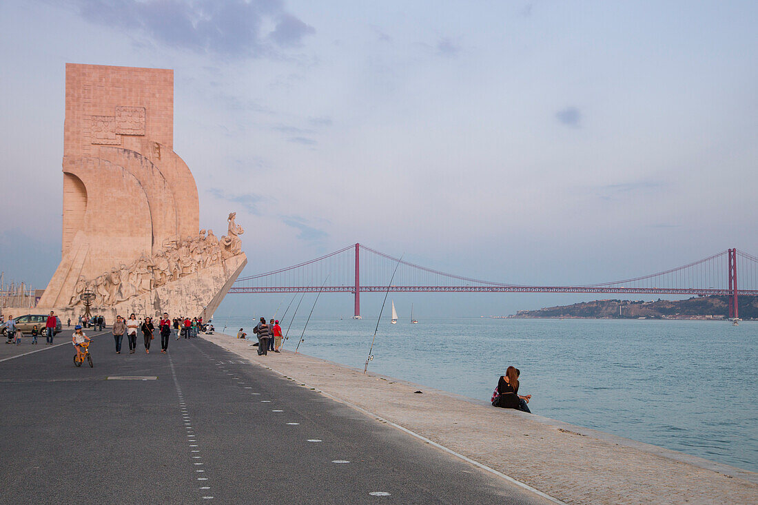 Padrao dos Descobrimentos, Discoveries Monument in Belem and Ponte 25 de Abril bridge over the Tagus river at sunset, Lisbon, Lisboa, Portugal