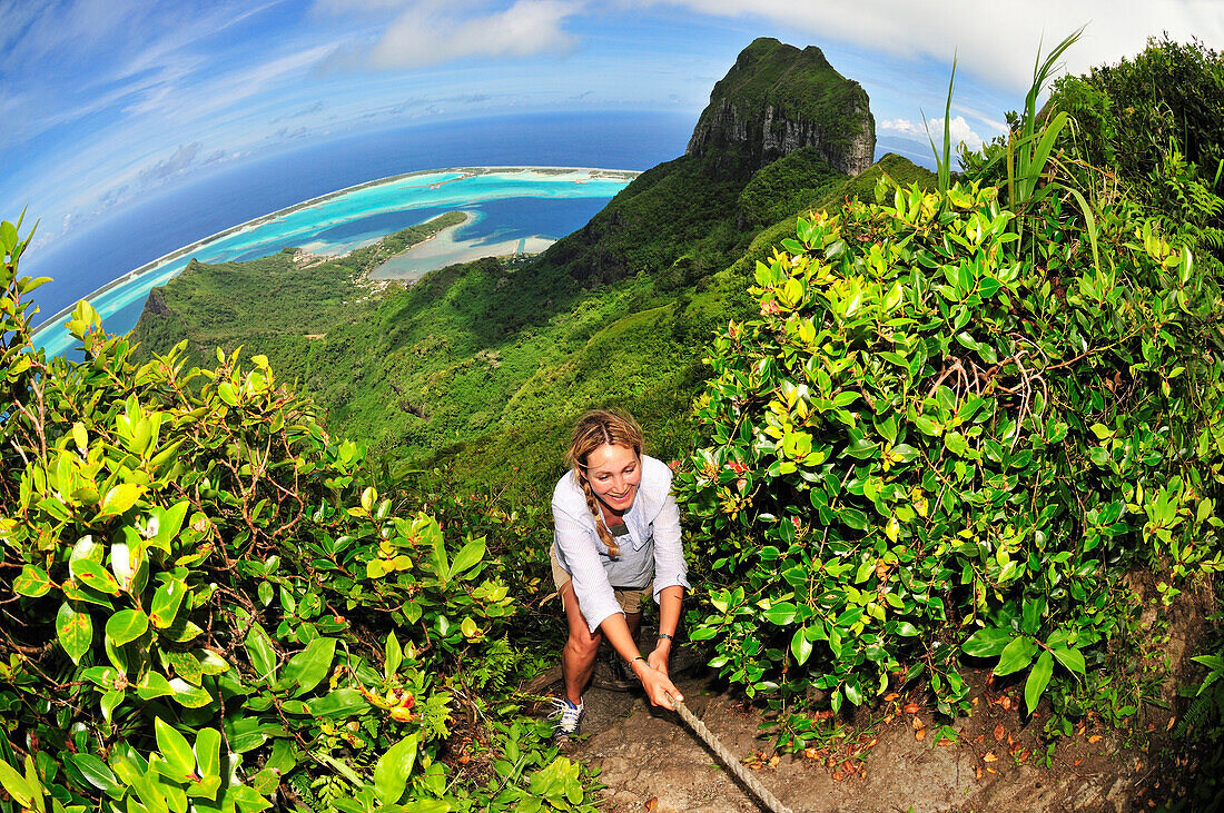 Woman trekking up Mount Pahia, Bora Bora, Society Islands, French Polynesia, Windward Islands, South Pacific