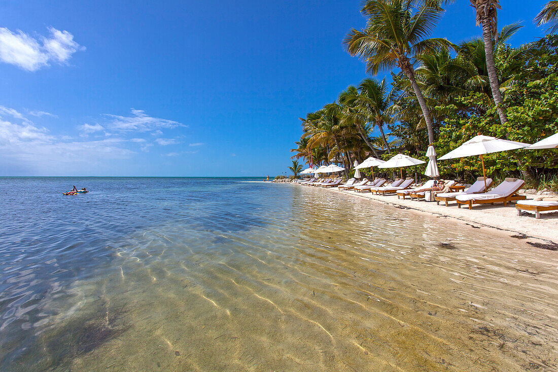 Beach with tourists, Little Palm Island Resort, Florida Keys, USA
