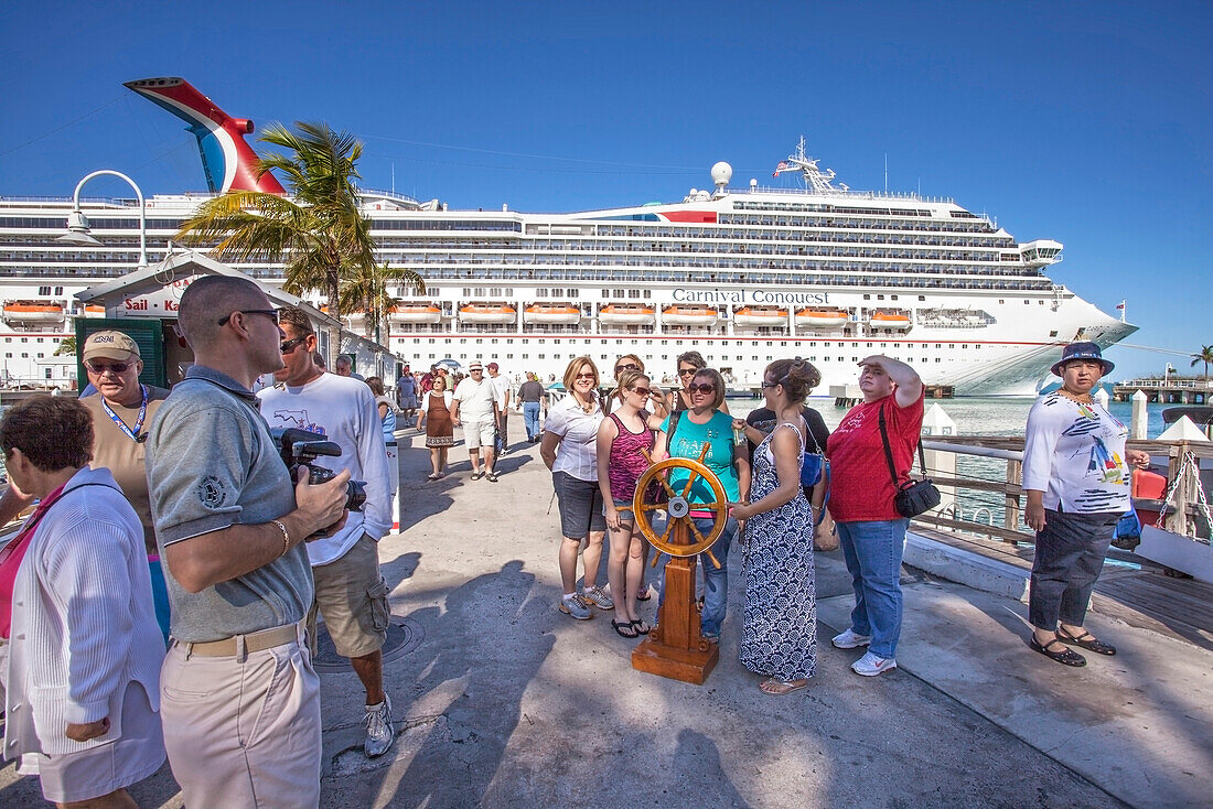 Tourists in front of luxury cruise ship docked at the port of Key West, Florida Keys, Florida, USA