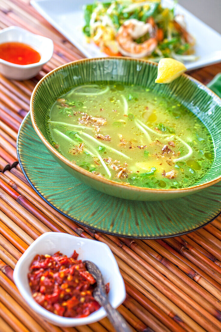 Soto Ayam, spiced chicken broth with rice noodles, bean sprouts, lemon grass, egg and galanga, Restaurant Indomania, South Beach, Miami, Florida, USA